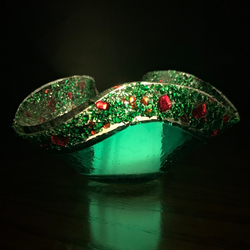 Illuminated Emerald Green Christmas Votive with red glass flecks along the rim